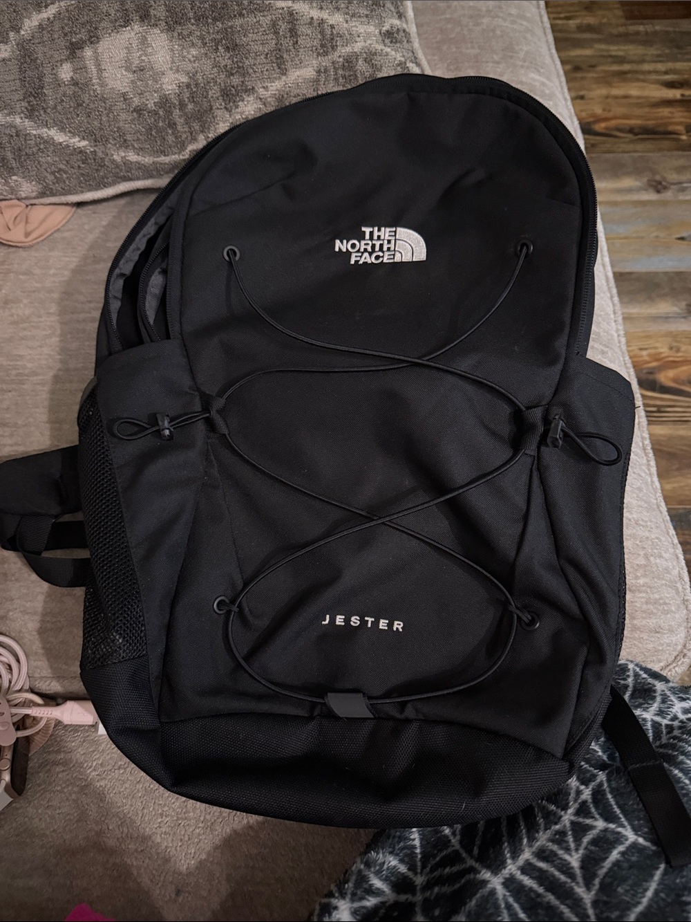 The North Face Jester Backpack in black with bungee front